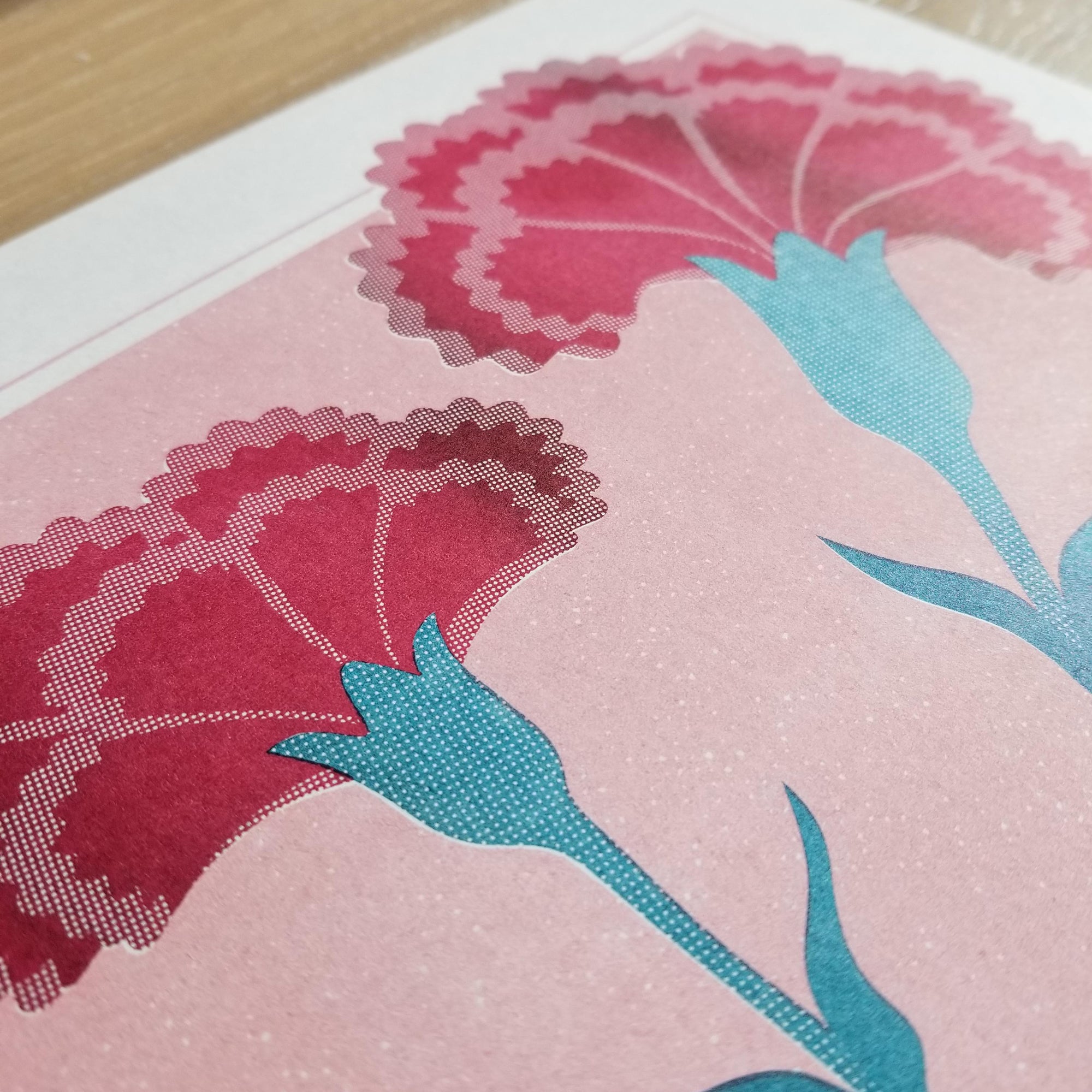 Risograph printed flowers in red, teal, and light mauve
